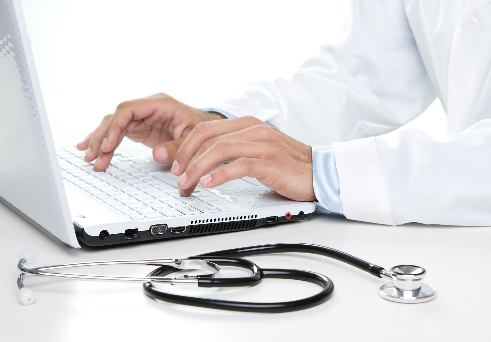 Healthcare professional working on a laptop