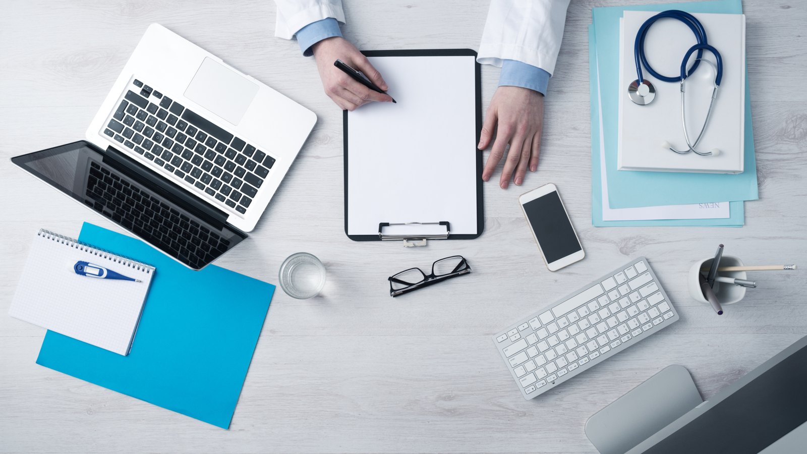 Medical workspace with a laptop and stethoscope